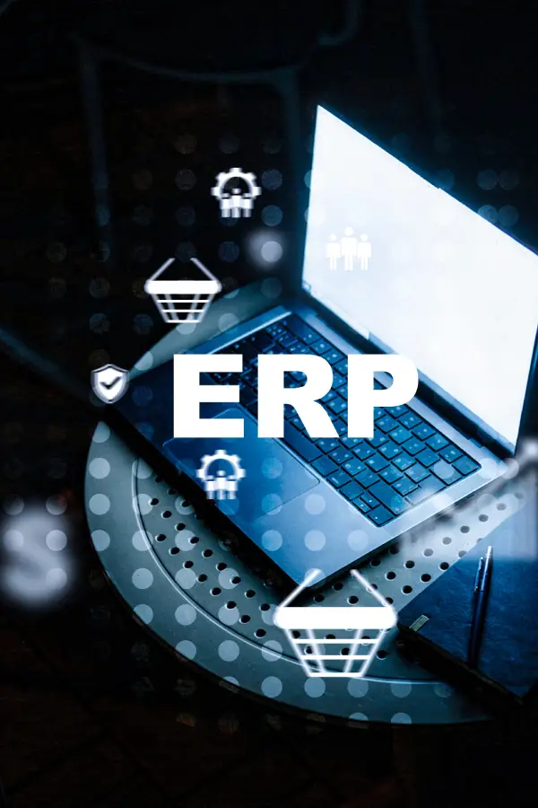 A laptop displaying the word ERP on the screen, surrounded by digital icons representing various business functions like shopping carts and settings