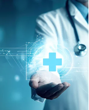 A doctor's open hand holding a glowing blue medical cross surrounded by digital graphics.